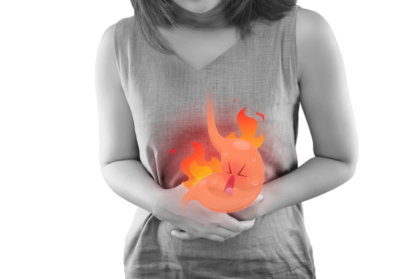 indigestion issues woman holding stomach with toony stomach burning pain